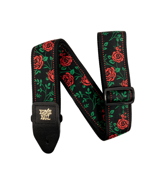 A guitar strap with a black background, featuring a red rose and green vine floral pattern, with a black leather tip and a gold 'Ernir Ball' brand logo.